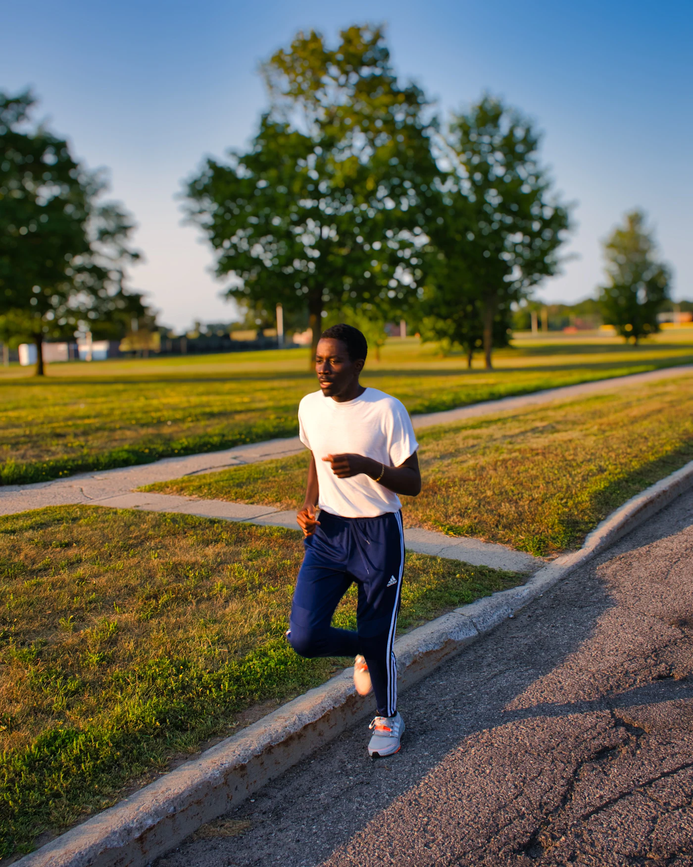 Mock photo: a Black man jogging through a park at golden hour. Replaced by store photography from the shoot.