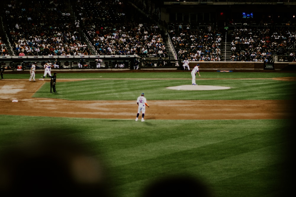 man in white shirt standing on green field