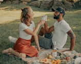 A joyful couple enjoying a picnic in a sunny park.