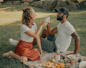 A happy couple enjoying a picnic, symbolizing meaningful connections.