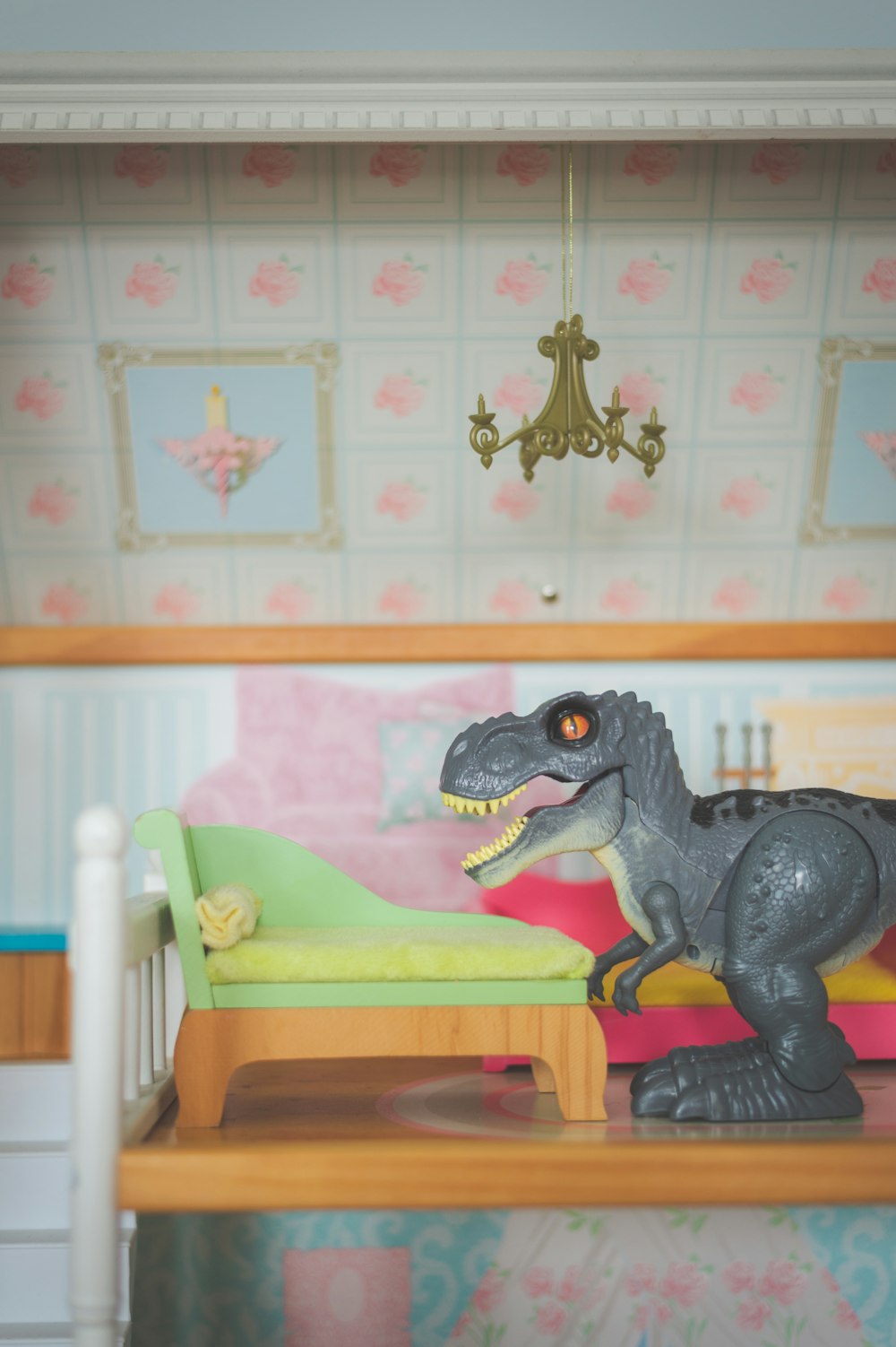 black and gray dinosaur toy on yellow and green wooden table
