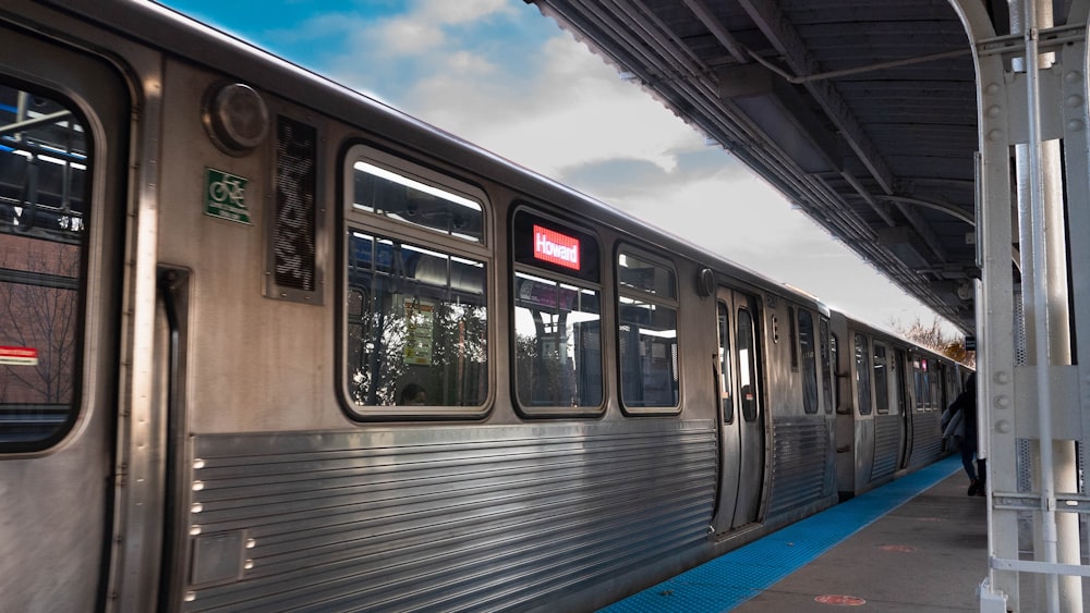 white and black train under white clouds during daytime