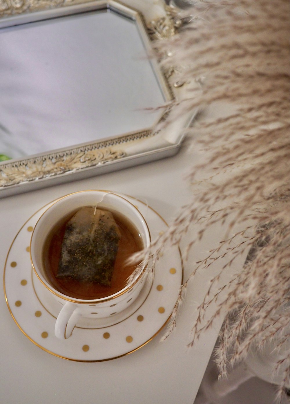 white ceramic teacup on saucer