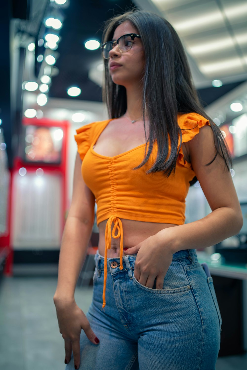 Woman in orange tank top and blue denim shorts photo – Free Clothing Image  on Unsplash