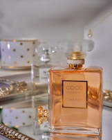 clear glass perfume bottle on white table