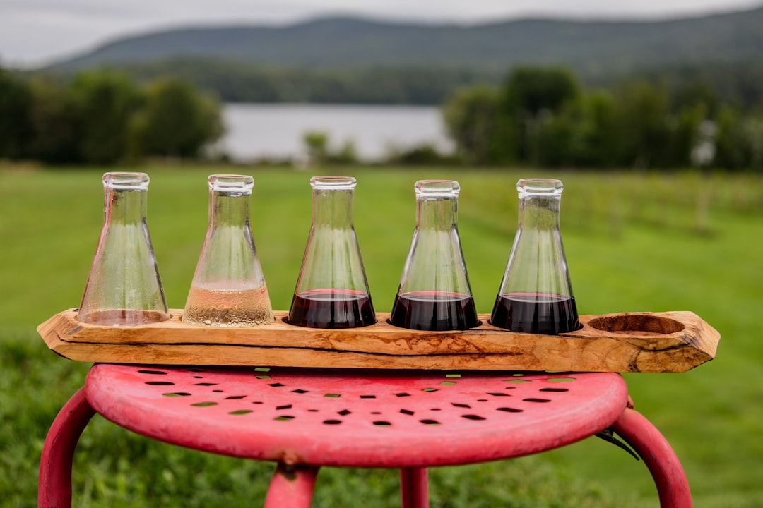 2 clear glass bottles on red table