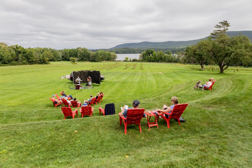 red and white chairs on green grass field during daytime