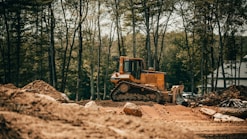 yellow and black heavy equipment on brown soil