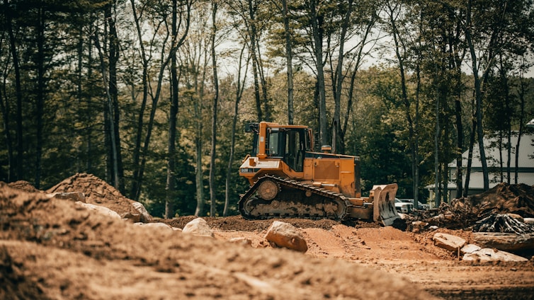 yellow and black heavy equipment on brown soil