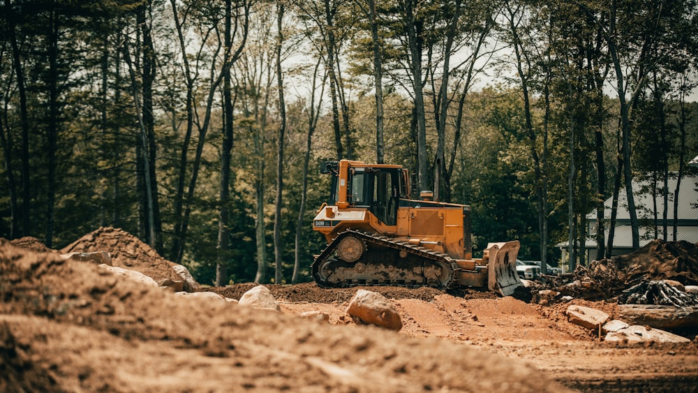 yellow and black heavy equipment on brown soil