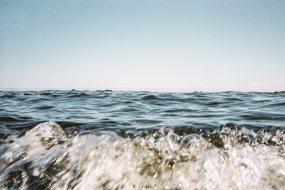 ocean waves under blue sky during daytime