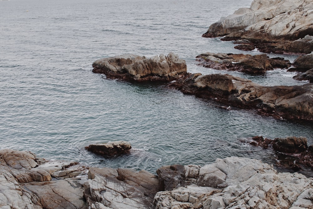 brown rock formation on sea during daytime