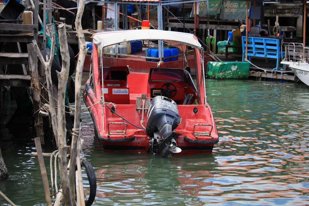 red and white boat on water