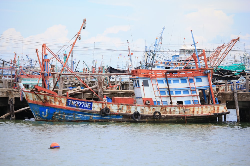 blue and red boat on water during daytime