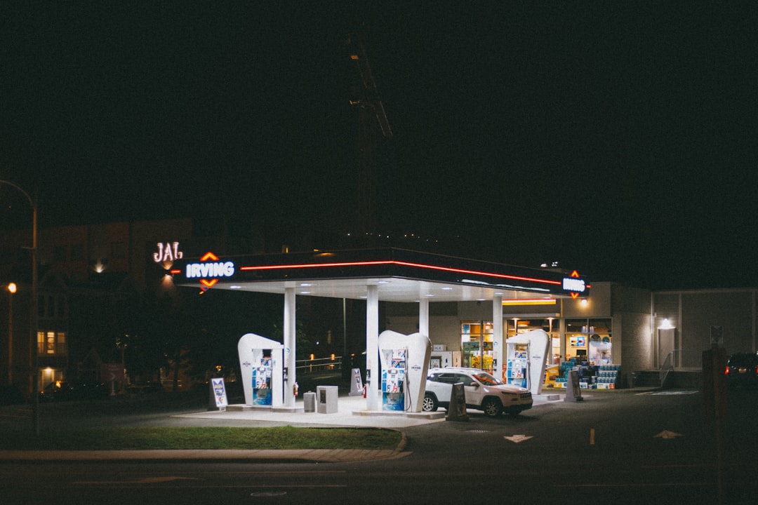 cars parked in front of store during night time