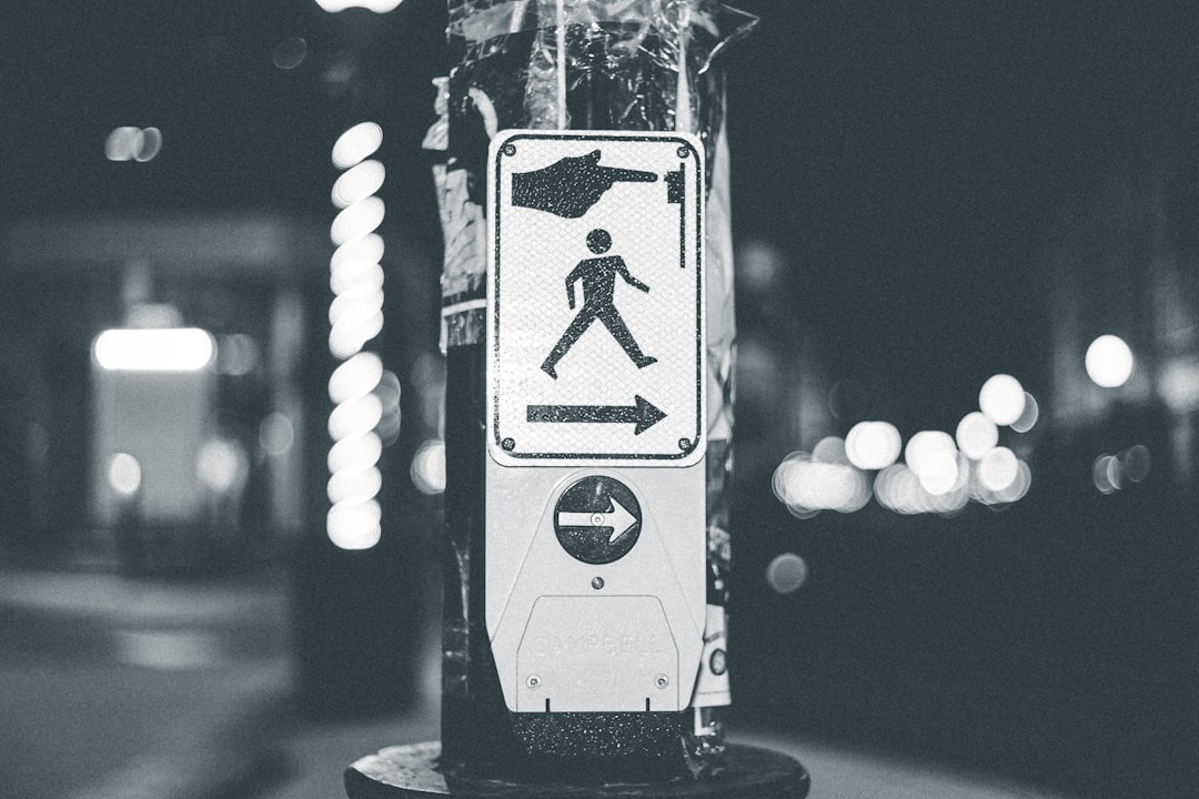 grayscale photo of a black and white street sign