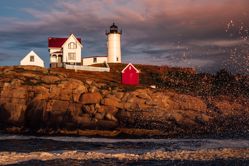 white and red lighthouse on brown rock formation during night time