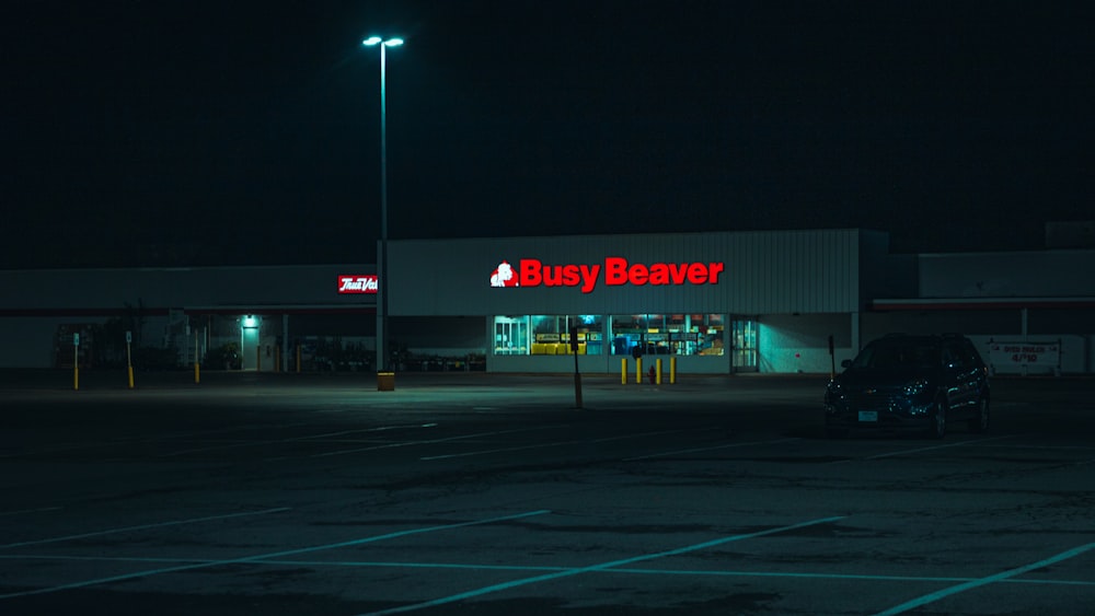 red and white store signage during night time