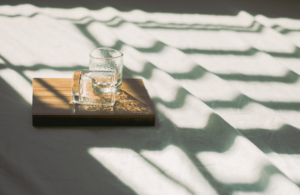 clear shot glass on brown wooden board