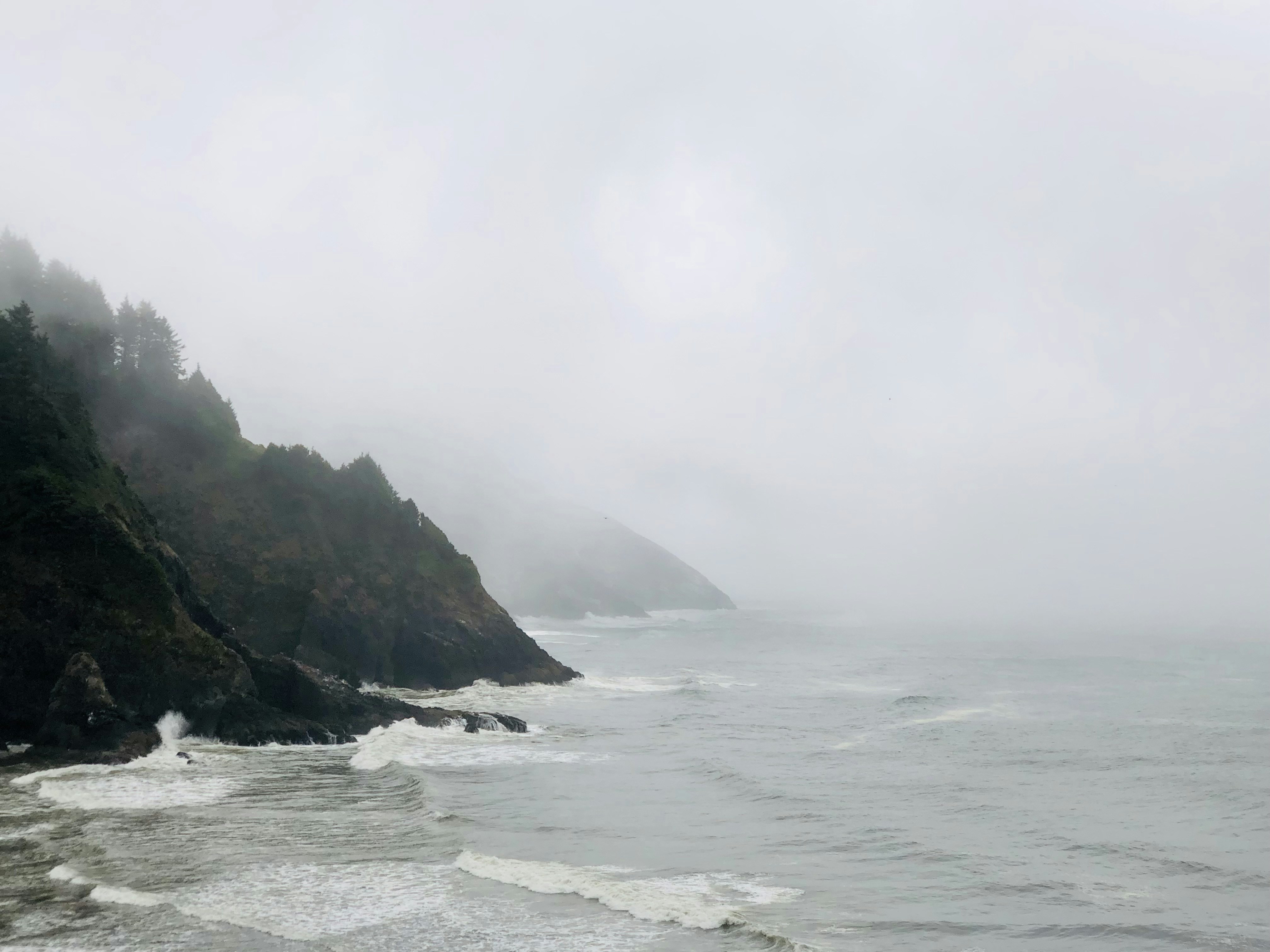 black rock formation on sea water during daytime