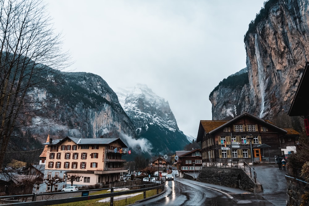 brown and white concrete buildings near mountain during daytime