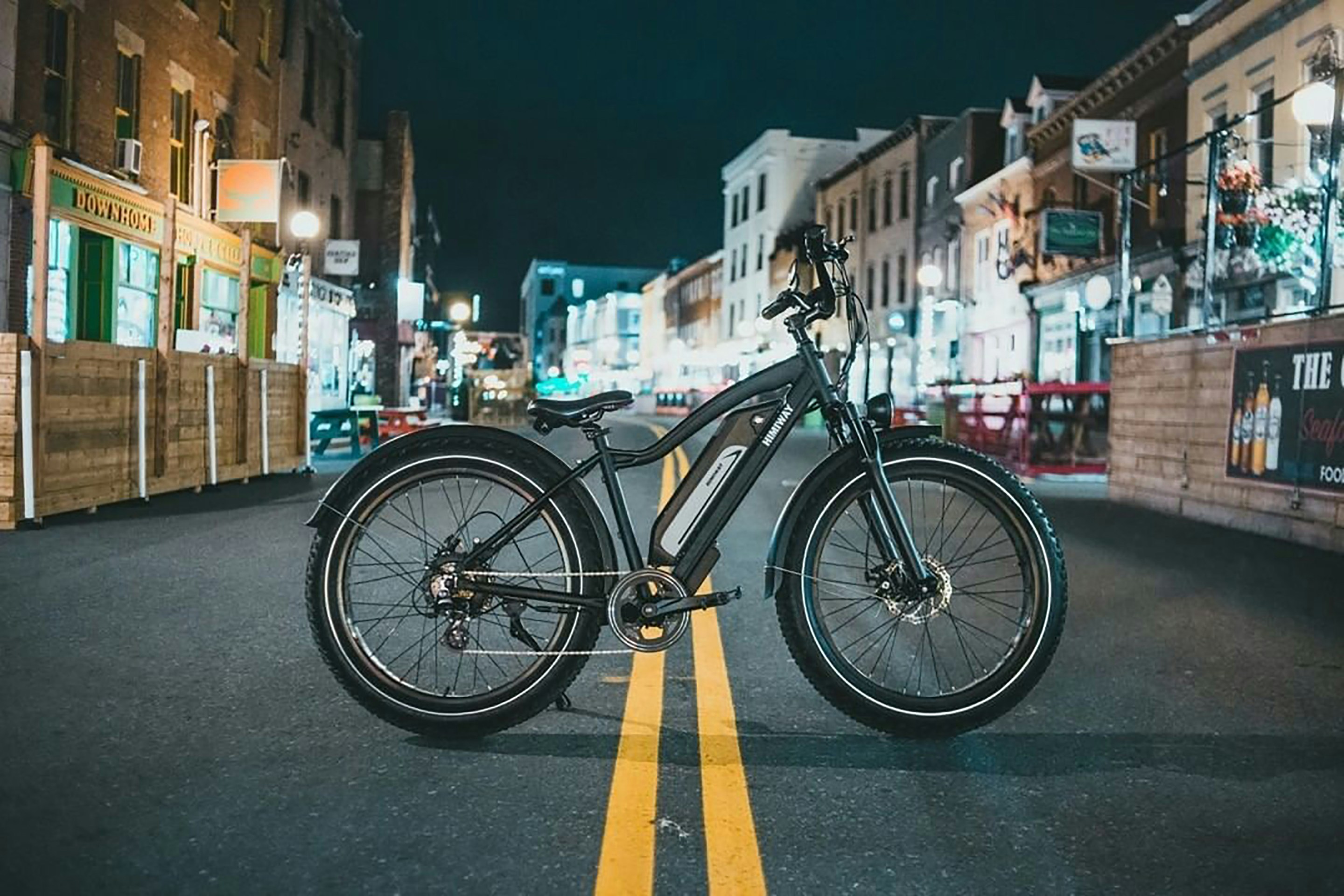 black and yellow bicycle on road during daytime