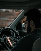 A truck driver using a tablet to log hours.