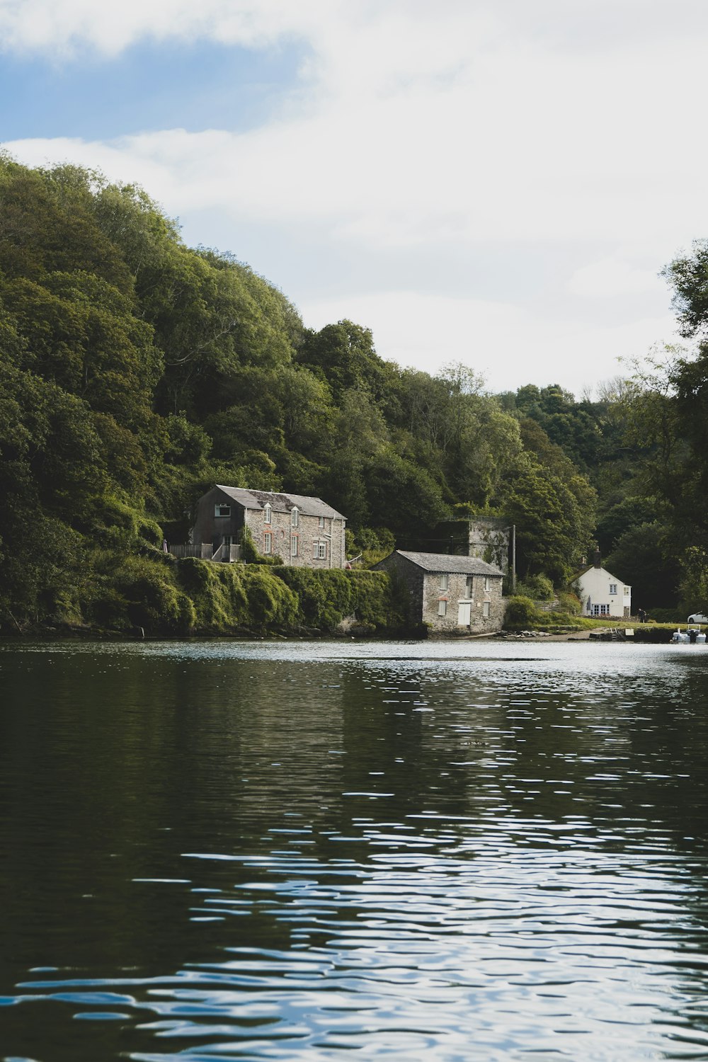 gray concrete house near body of water during daytime