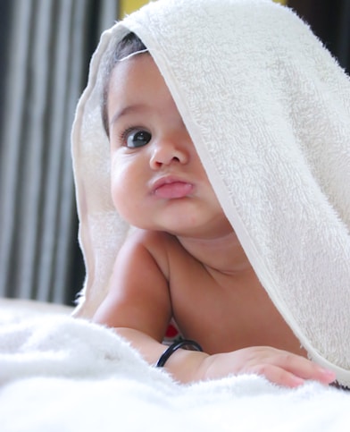 Baby in a white bath towel