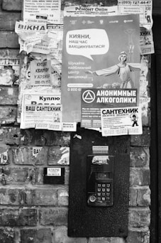 grayscale photo of telephone booth