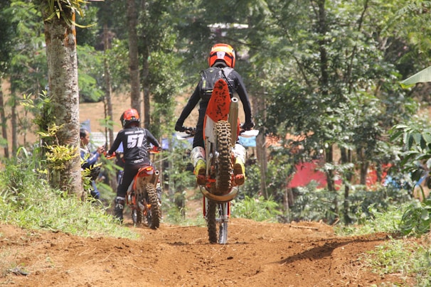 An aerial view of a group of bikers on a mountain trail.