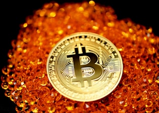 silver and gold round Bitcoin