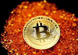 silver and gold round Bitcoin