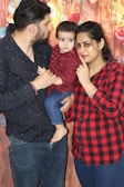 A happy family posing together in matching outfits.