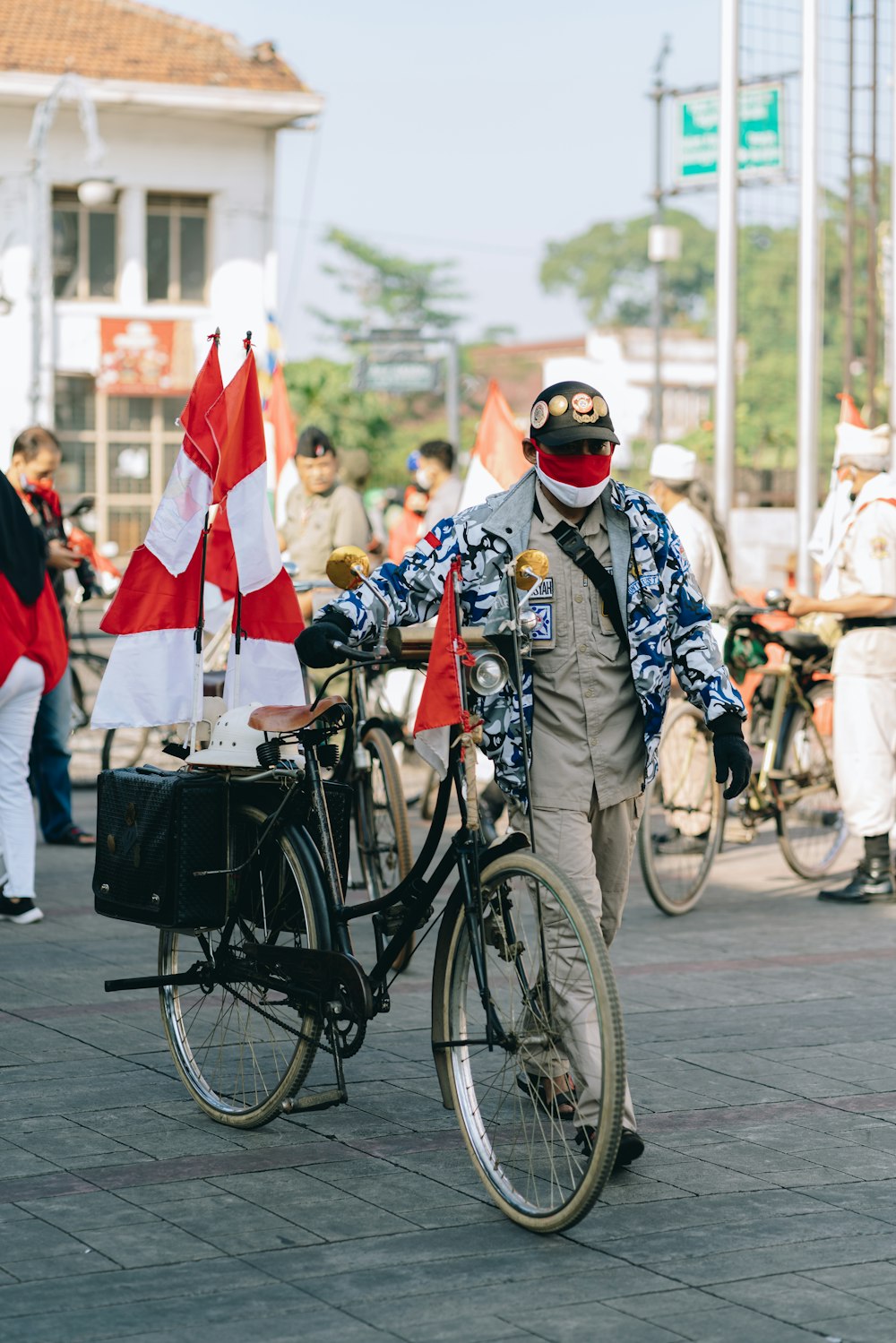 man in black and white long sleeve shirt riding on black bicycle