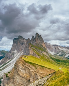green and brown mountain under cloudy sky during daytime