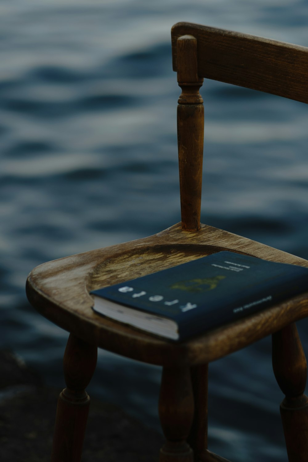 black and white book on brown wooden chair