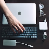 silver macbook beside white apple earpods