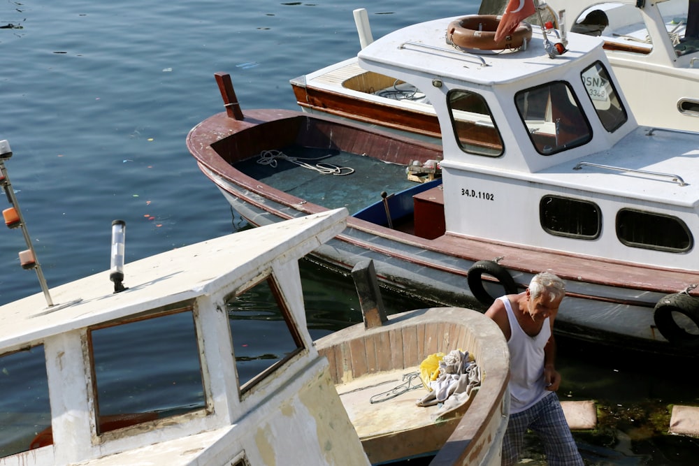 man in white t-shirt sitting on boat during daytime