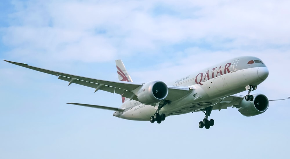 avião de passageiros branco e vermelho no céu