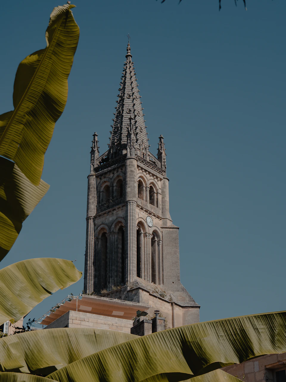 Gothic stone church spire against a clear sky in the Gironde