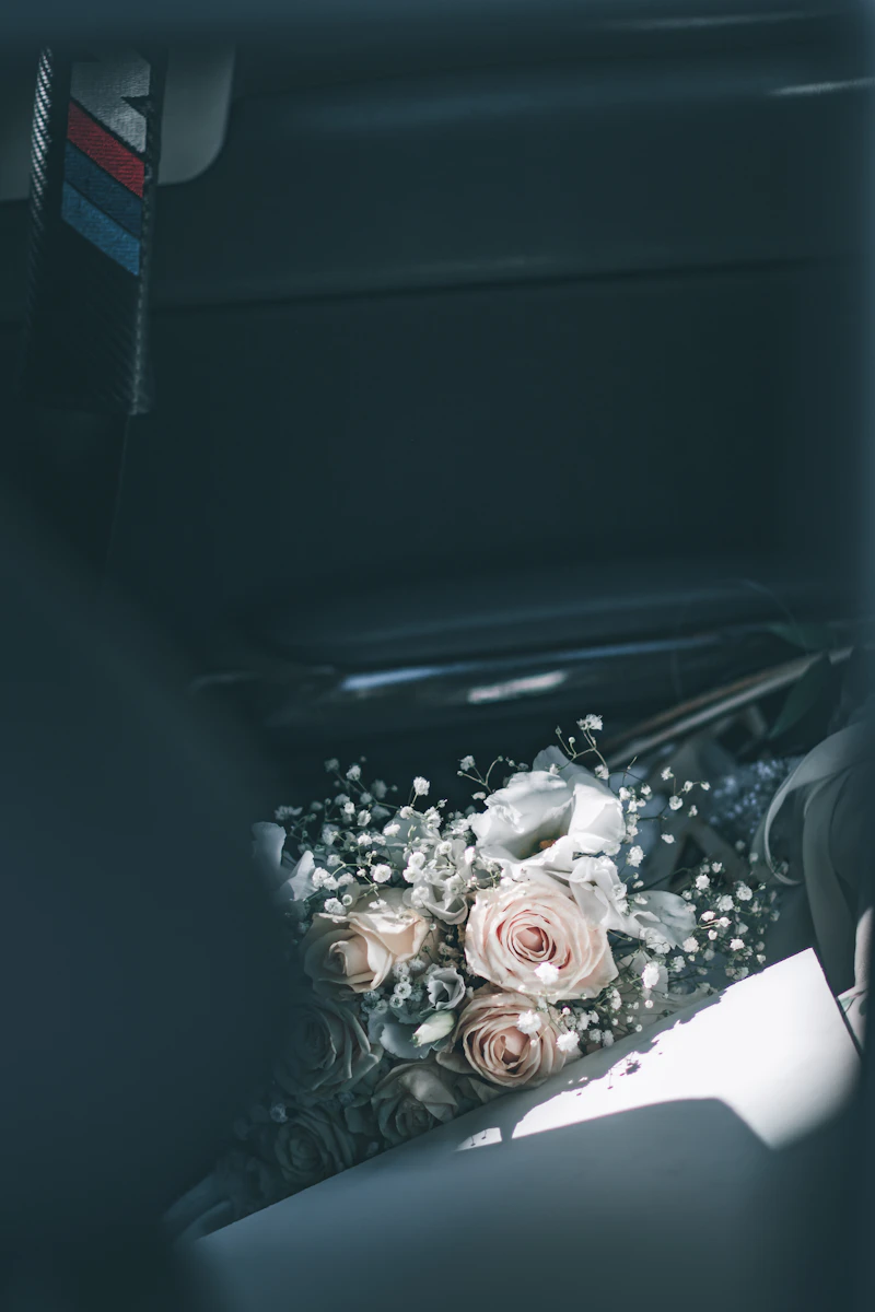Bouquet of white roses on a car seat