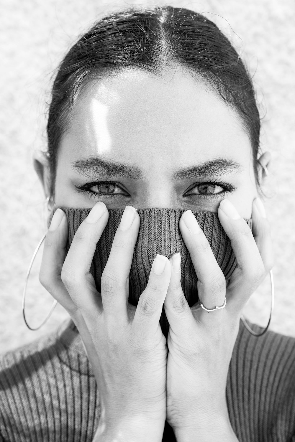 grayscale photo of woman covering her face with her hands