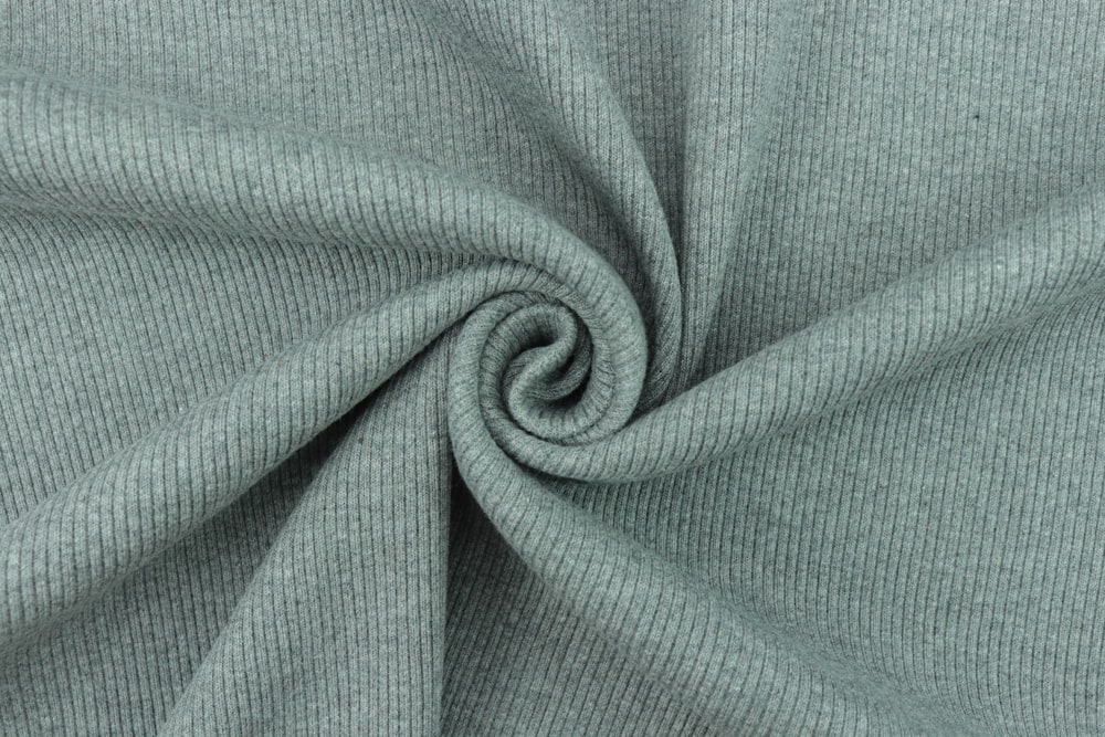 green textile in close up photography