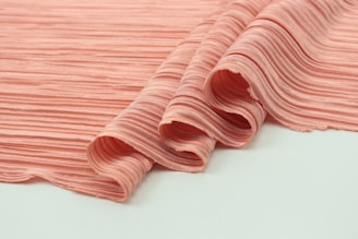 pink and white stripe textile