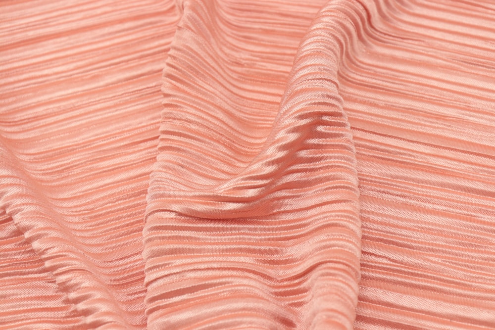 pink and white stripe textile