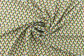 A fabric with a vibrant pattern featuring numerous stylized toucans arranged in a repeated motif, creating a lively visual texture. The fabric exhibits a swirling effect, emphasizing the flow and softness of the material.