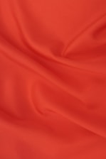 red textile on brown wooden table
