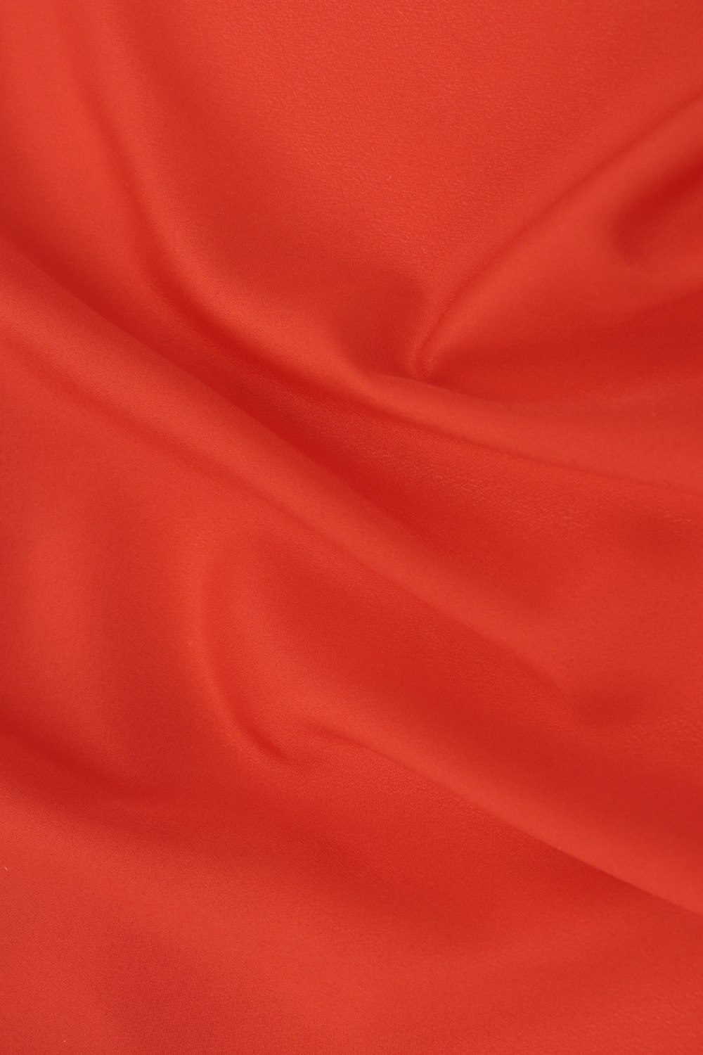 red textile on brown wooden table