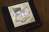 black tablet computer on brown wooden table